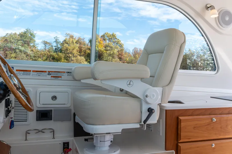 Slide: The Image of Captain's chair in 2023 Back Cove 340 boat, featuring luxurious design and wooden accents. - 25