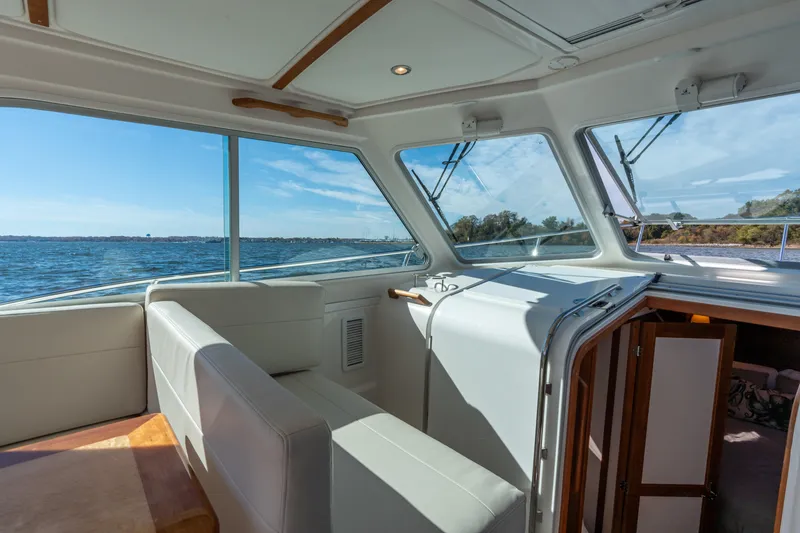 Slide: The Image of Interior view of 2023 Back Cove 340 boat with seating and scenic water view. - 30
