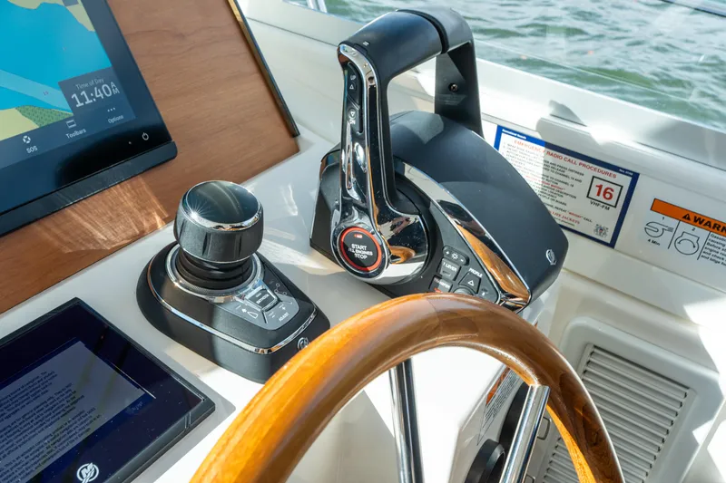 Slide: The Image of Helm controls of 2023 Back Cove 340 boat with touchscreen and joystick. - 31