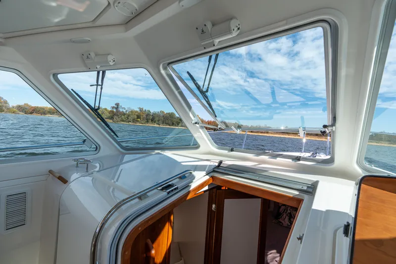 Slide: The Image of 2023 Back Cove 340 boat interior with open cabin door and scenic water view. - 38