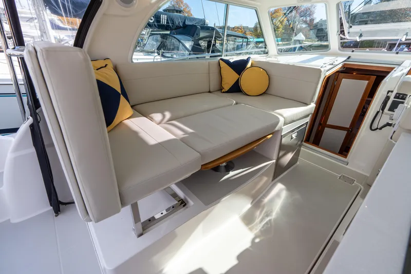 Slide: The Image of 2023 Back Cove 340 interior with beige seating and decorative pillows, showcasing modern design. - 42