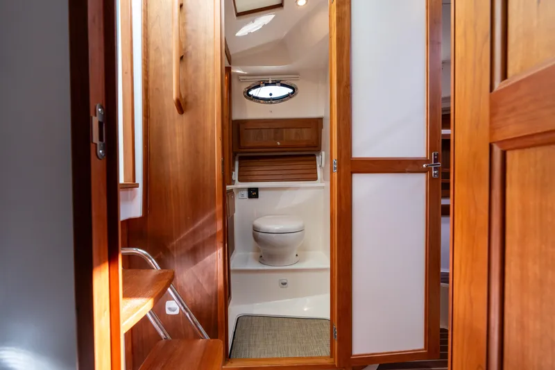 Slide: The Image of 2023 Back Cove 340 yacht interior bathroom with wooden finish and modern amenities. - 44