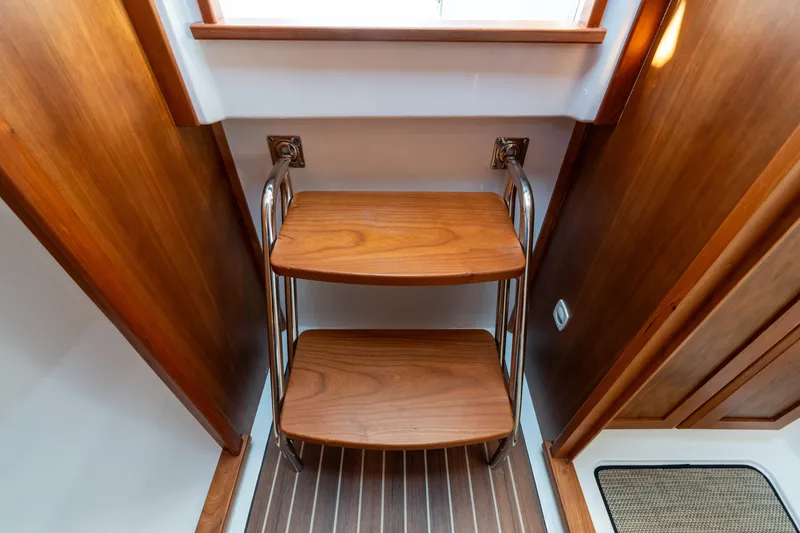 Slide: The Image of Wooden steps inside 2023 Back Cove 340 boat, featuring sleek metal railings. - 46