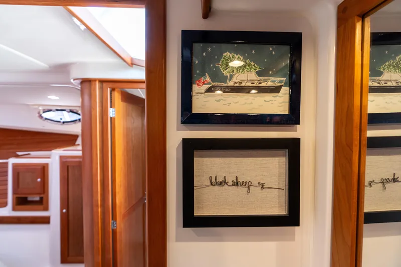 Slide: The Image of Interior of 2023 Back Cove 340 yacht with framed artwork and wooden finishes. - 47