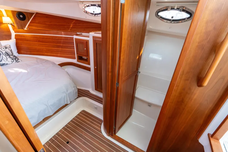 Slide: The Image of 2023 Back Cove 340 interior with wooden finishes and cozy cabin space. - 48