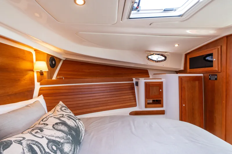 Slide: The Image of Luxurious cabin interior of 2023 Back Cove 340 yacht with wood accents and cozy bedding. - 52
