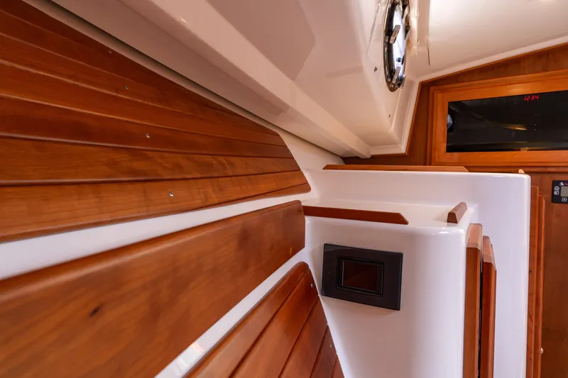 Slide: The Image of 2023 Back Cove 340 interior with polished wood paneling and modern design elements. - 56