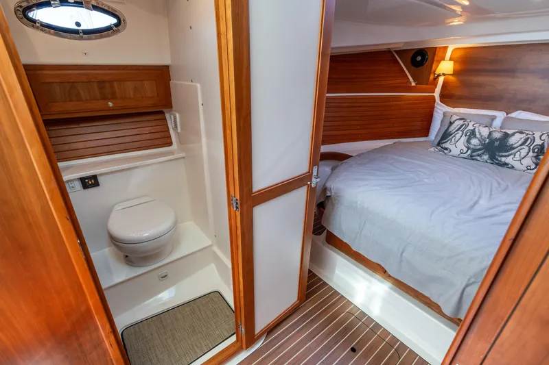 Slide: The Image of 2023 Back Cove 340 interior with cozy bedroom and compact bathroom. - 58