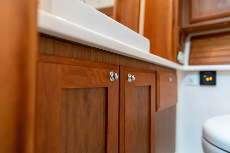 Slide: The Image of 2023 Back Cove 340 interior with wooden cabinetry and modern fixtures. - 60