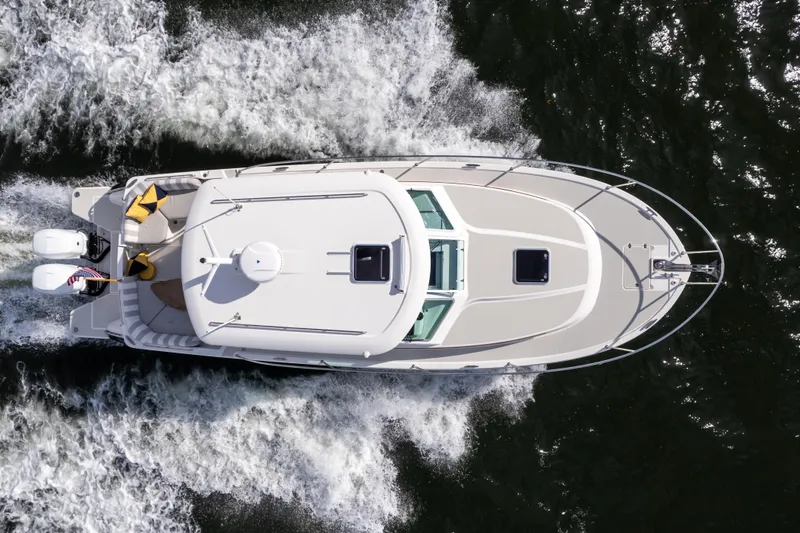 Slide: The Image of Aerial view of 2023 Back Cove 340 boat cruising on water. - 72