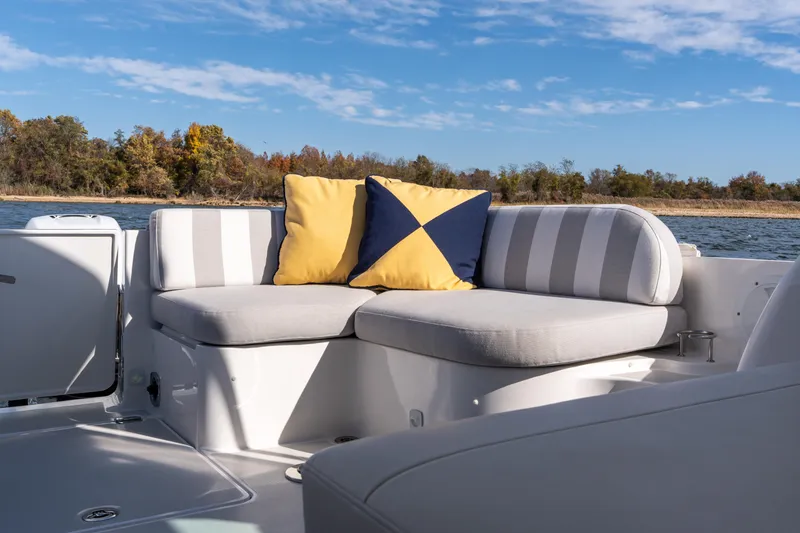 Slide: The Image of 2023 Back Cove 340 boat with striped seating and colorful cushions on a sunny day. - 9