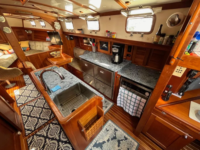 Slide: The Image of Luxurious 1996 Gozzard 44 AC yacht interior with elegant wood finish and modern kitchen amenities. - 12