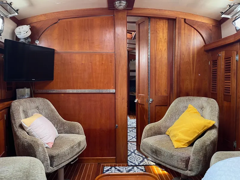 Slide: The Image of Cozy interior of 1996 Gozzard 44 AC yacht with plush chairs and wooden paneling. - 15