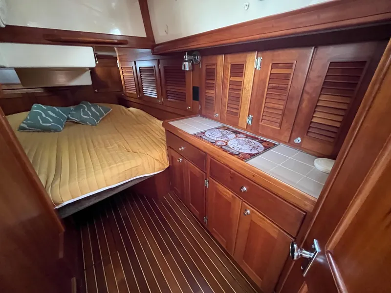 Slide: The Image of Cozy cabin interior of 1996 Gozzard 44 AC with wooden cabinetry and bed. - 21