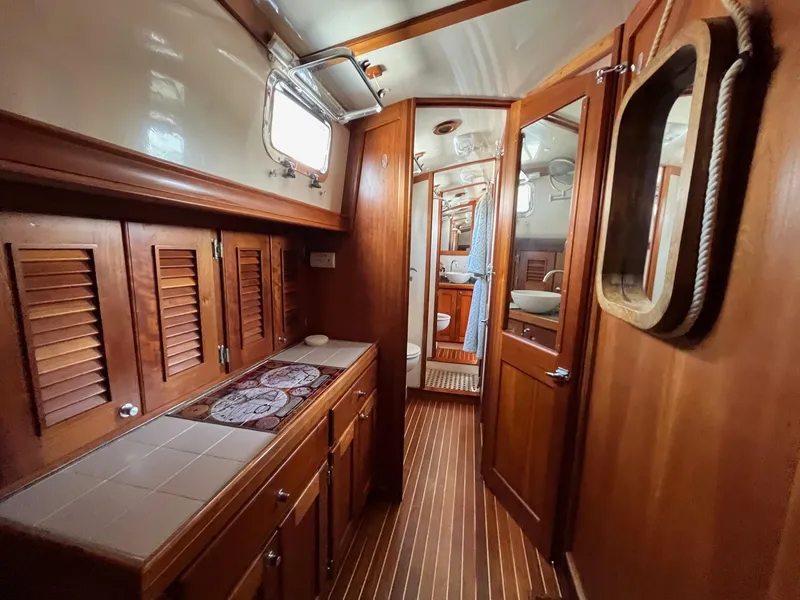 Slide: The Image of Interior of 1996 Gozzard 44 AC yacht with wooden cabinetry and nautical decor. - 22