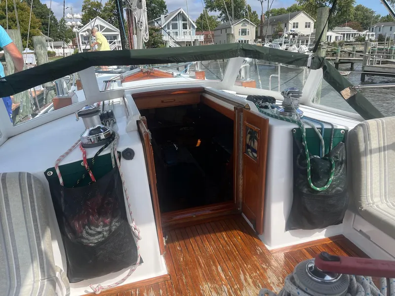 Slide: The Image of Cockpit of 1996 Gozzard 44 AC sailboat with wooden flooring and storage bags. - 9