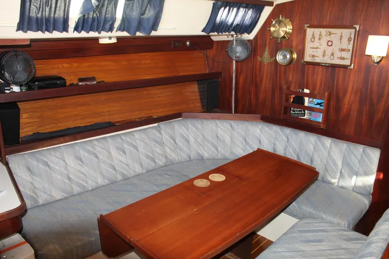 Slide: The Image of Interior of a 1990 Catalina 42 sailboat with cozy seating and wooden table. - 28