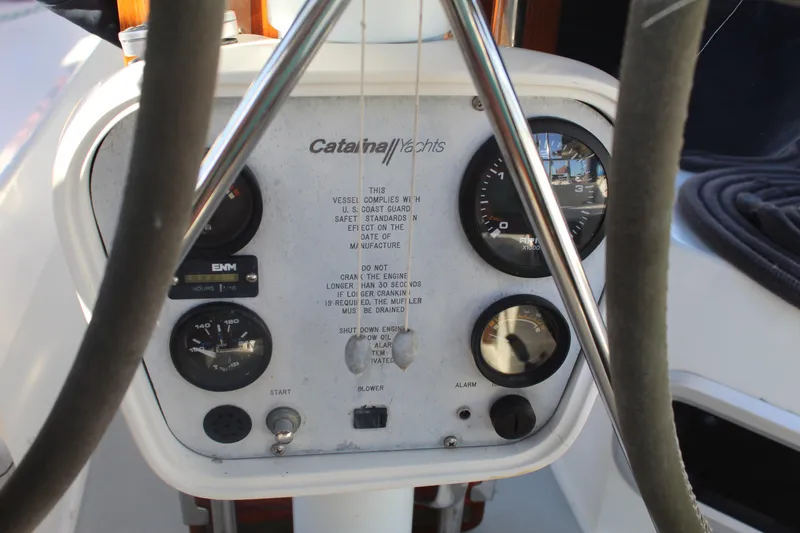 Slide: The Image of Control panel of a 1990 Catalina 42 yacht with gauges and warning labels. - 47
