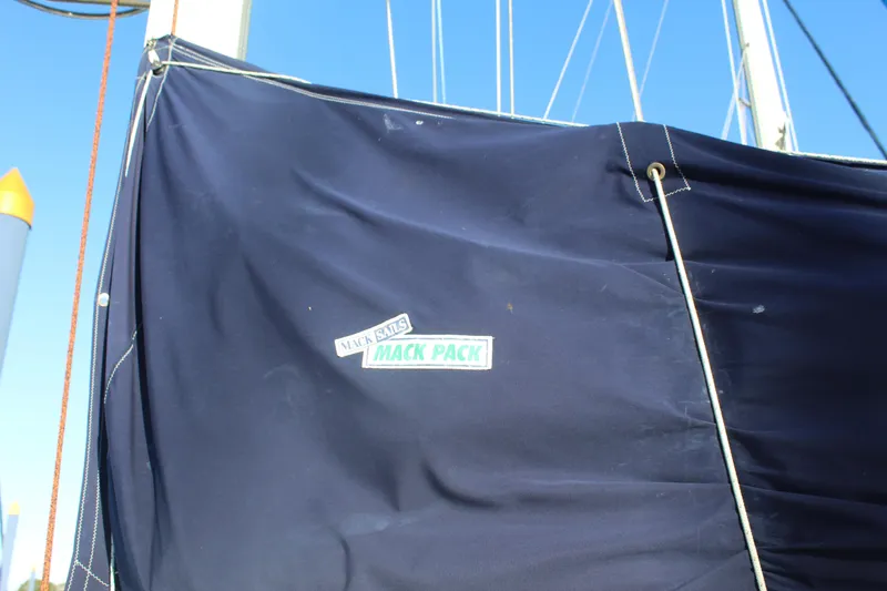 Slide: The Image of Blue sail cover on a 1990 Catalina 42 sailboat with Mack Pack branding. - 43