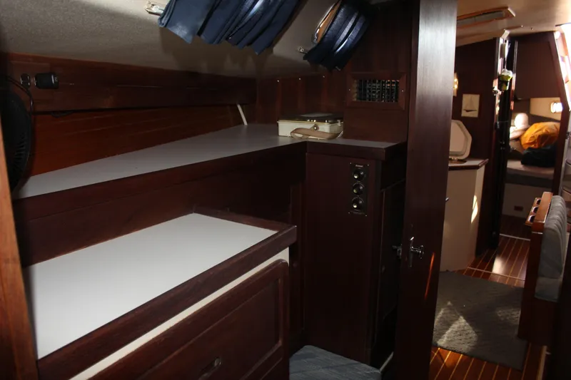 Slide: The Image of Interior of a 1990 Catalina 42 sailboat with wooden cabinetry and cozy sleeping area. - 19