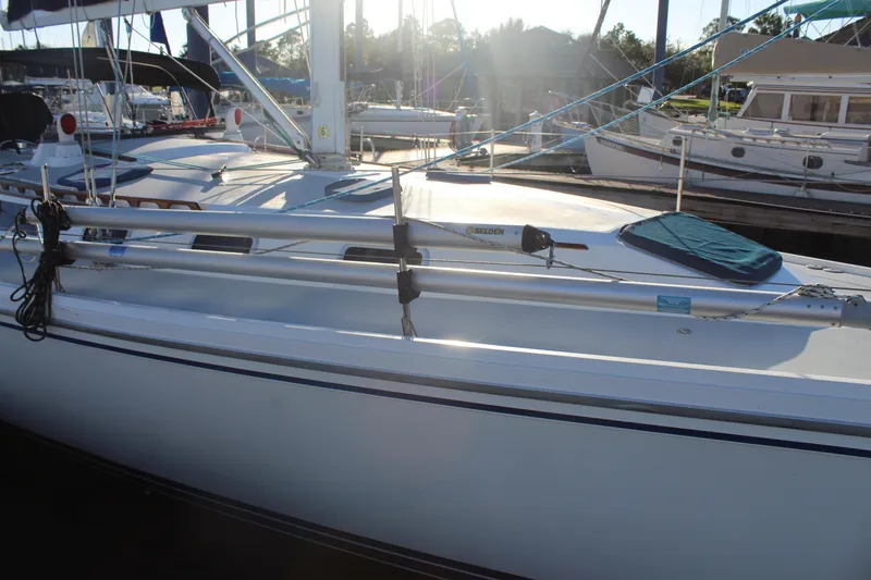 Slide: The Image of 1990 Catalina 42 sailboat docked, featuring sleek design and modern rigging. - 46