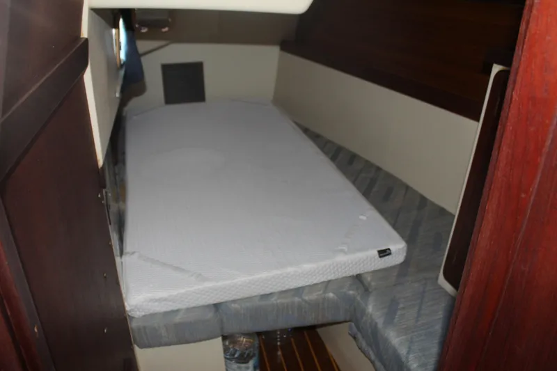 Slide: The Image of Interior cabin of a 1990 Catalina 42 sailboat with a cushioned berth. - 24