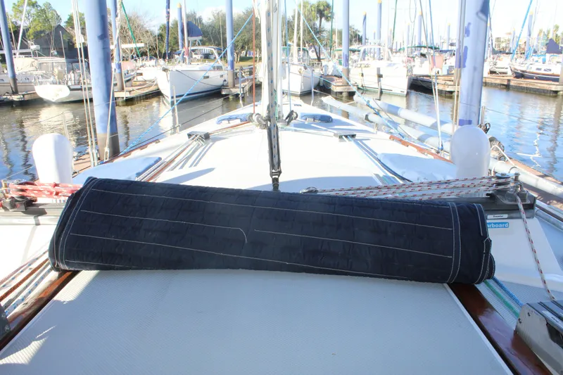 Slide: The Image of Catalina 42 sailboat deck, 1990 model, docked in marina with rigging visible. - 7