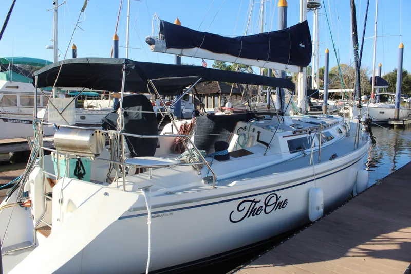 The Image of Sailboat "The One" docked, 1990 Catalina 42 model, sunny marina setting. - 0