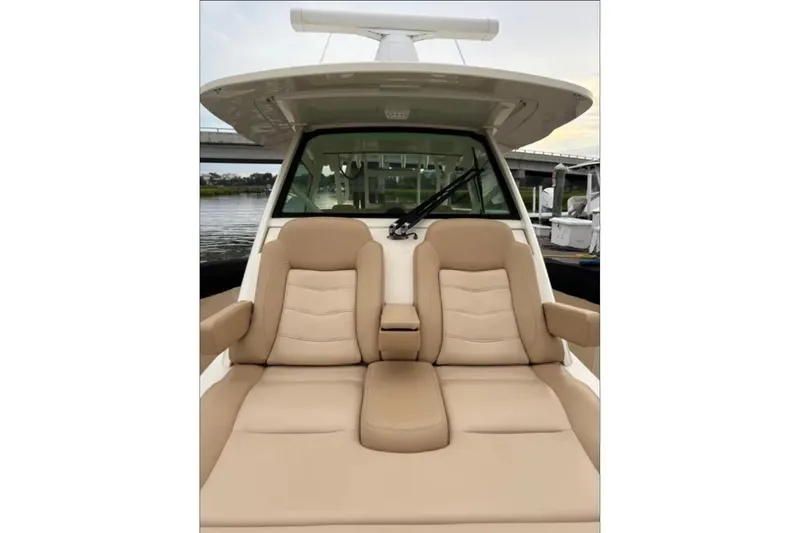 Slide: The Image of 2019 Scout 380 LXF boat with luxurious tan seating and sleek design. - 12