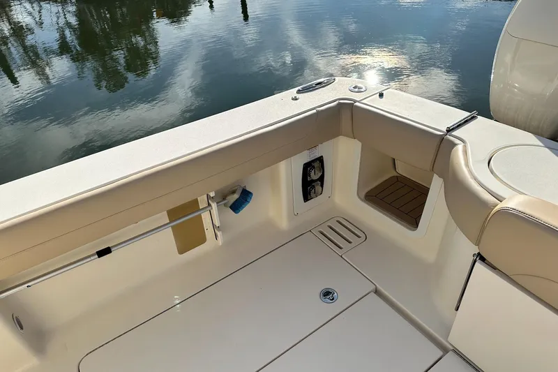 Slide: The Image of 2019 Scout 380 LXF boat interior with beige seating and water reflection. - 13