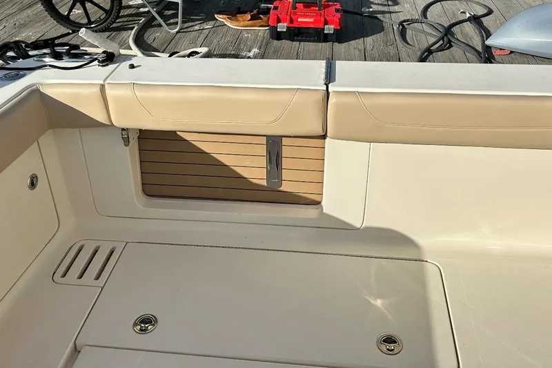 Slide: The Image of 2019 Scout 380 LXF boat interior with beige seating and wooden accents. - 15