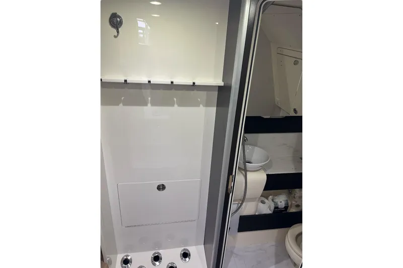 Slide: The Image of 2019 Scout 380 LXF boat bathroom interior with modern fixtures and storage. - 23