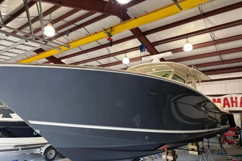 Slide: The Image of 2019 Scout 380 LXF boat in a warehouse, side view. - 31
