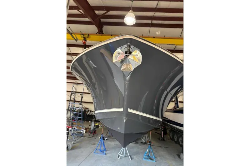 Slide: The Image of 2019 Scout 380 LXF boat in a warehouse, viewed from the front. - 33