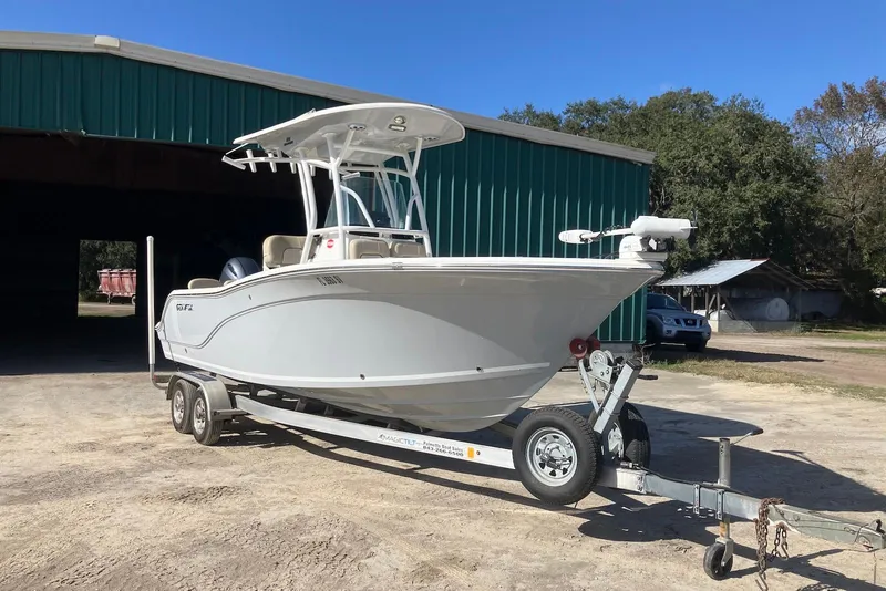 Slide: The Image of 2018 Sea Fox 226 Commander boat on trailer outside green building. - 1