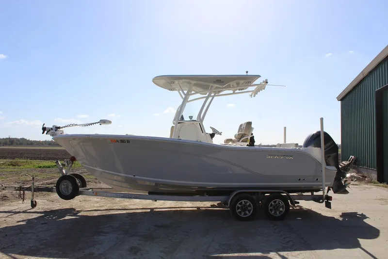Slide: The Image of 2018 Sea Fox 226 Commander boat on trailer, parked outdoors near a building. - 11