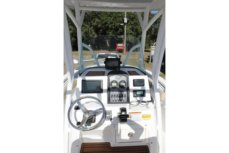 Slide: The Image of 2018 Sea Fox 226 Commander boat dashboard with steering wheel and navigation controls. - 16
