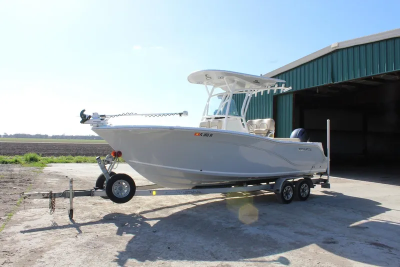 Slide: The Image of 2018 Sea Fox 226 Commander boat on trailer near a large shed. - 2