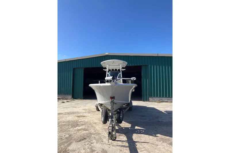 Slide: The Image of 2018 Sea Fox 226 Commander boat on trailer outside green warehouse. - 26