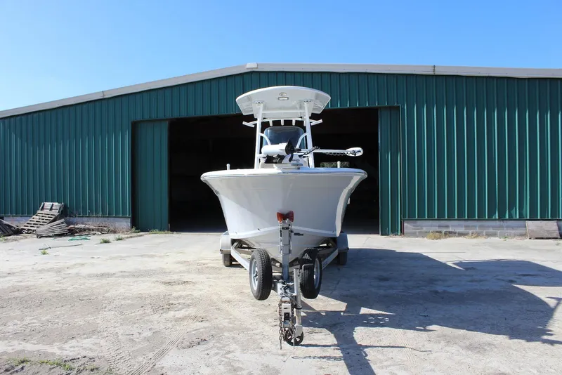 Slide: The Image of 2018 Sea Fox 226 Commander boat on trailer in front of green warehouse. - 27