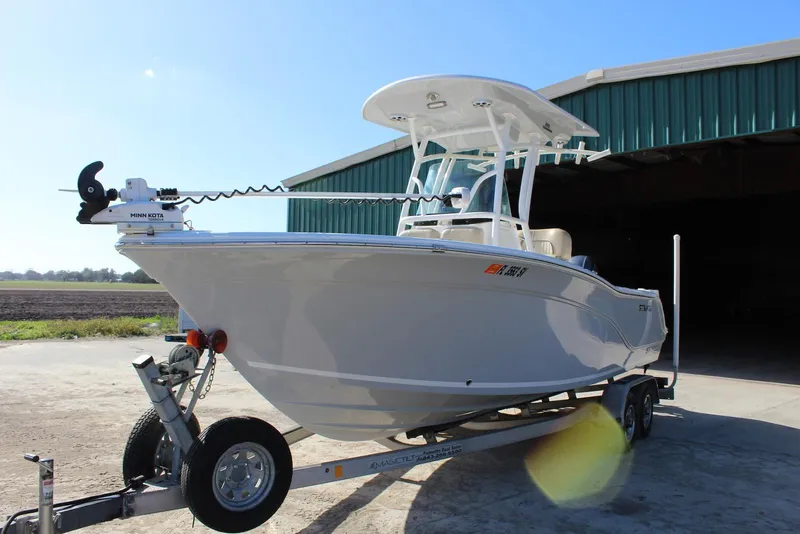 Slide: The Image of 2018 Sea Fox 226 Commander boat on trailer, parked outside a green building. - 31