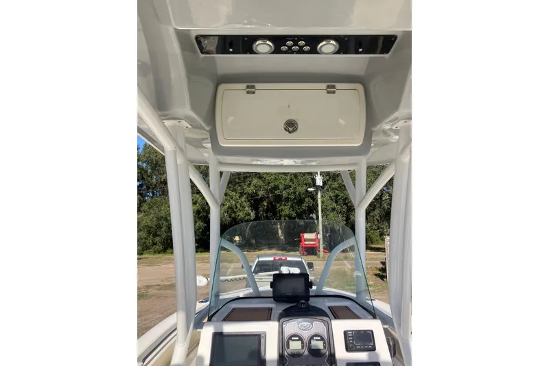 Slide: The Image of 2018 Sea Fox 226 Commander boat dashboard with navigation equipment and overhead storage. - 32