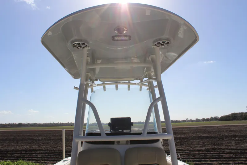 Slide: The Image of 2018 Sea Fox 226 Commander boat with T-top under clear blue sky. - 34