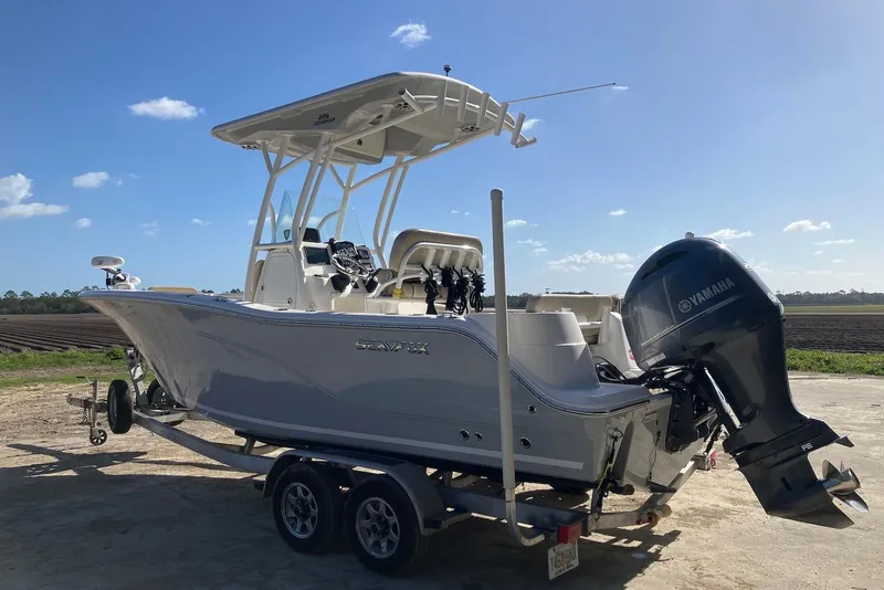 Slide: The Image of 2018 Sea Fox 226 Commander boat with Yamaha engine on trailer under clear sky. - 7