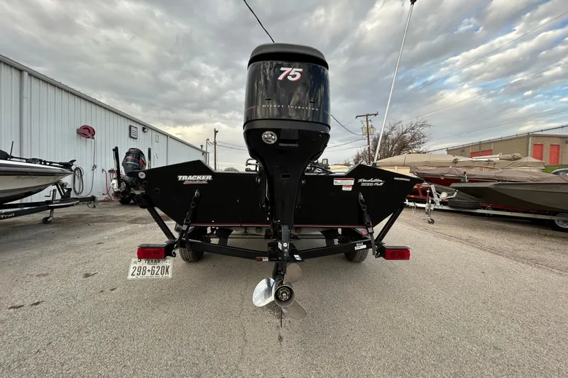 Slide: The Image of 2014 Bass Tracker PRO TEAM 175 TXW boat on trailer by a lake. - 2