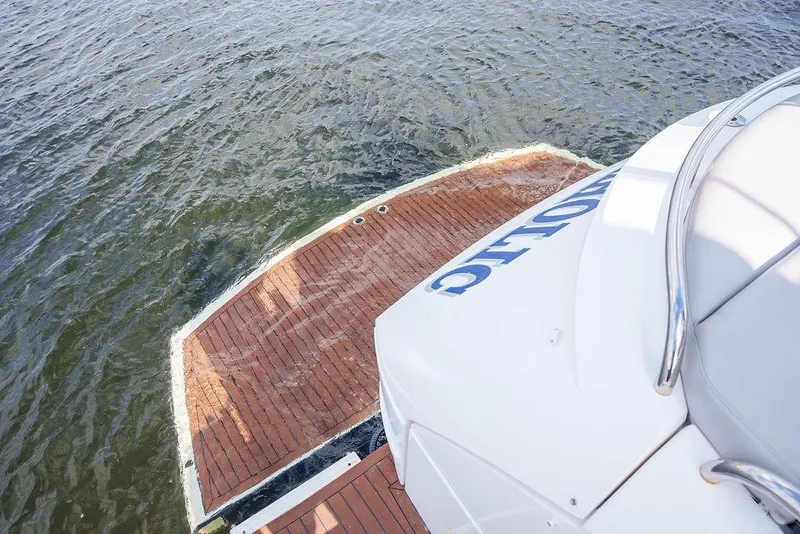 Slide: The Image of 2013 Sunseeker Portafino yacht with sleek design, docked by a scenic waterfront. - 13