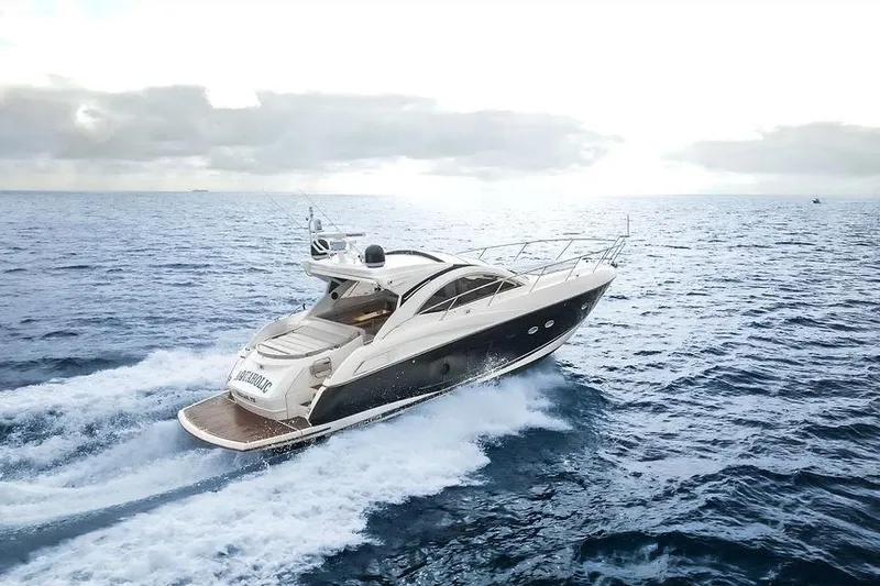Slide: The Image of 2013 Sunseeker Portafino yacht cruising on open sea under cloudy sky. - 2