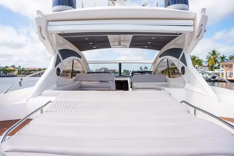 Slide: The Image of 2013 Sunseeker Portafino yacht on calm water with luxury waterfront homes in background. - 27