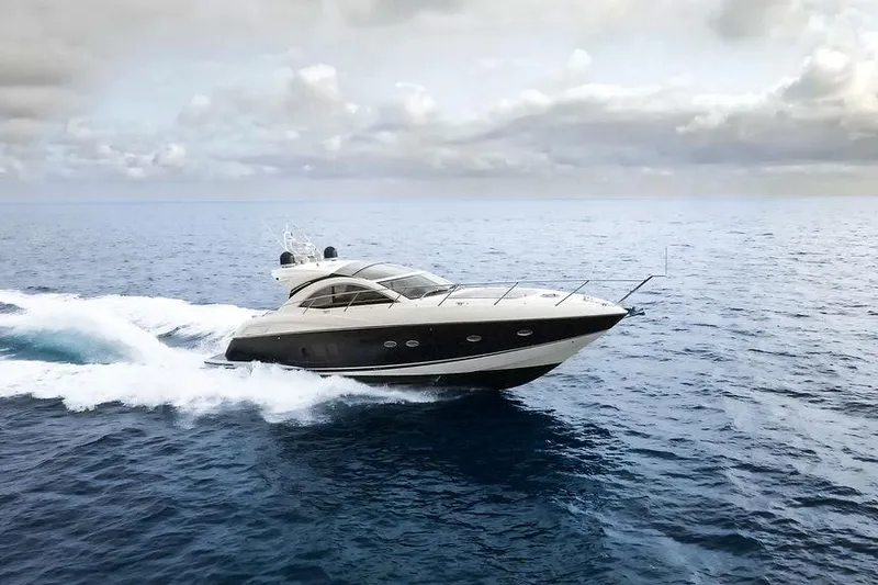 Slide: The Image of 2013 Sunseeker Portafino yacht cruising on open sea under cloudy sky. - 3