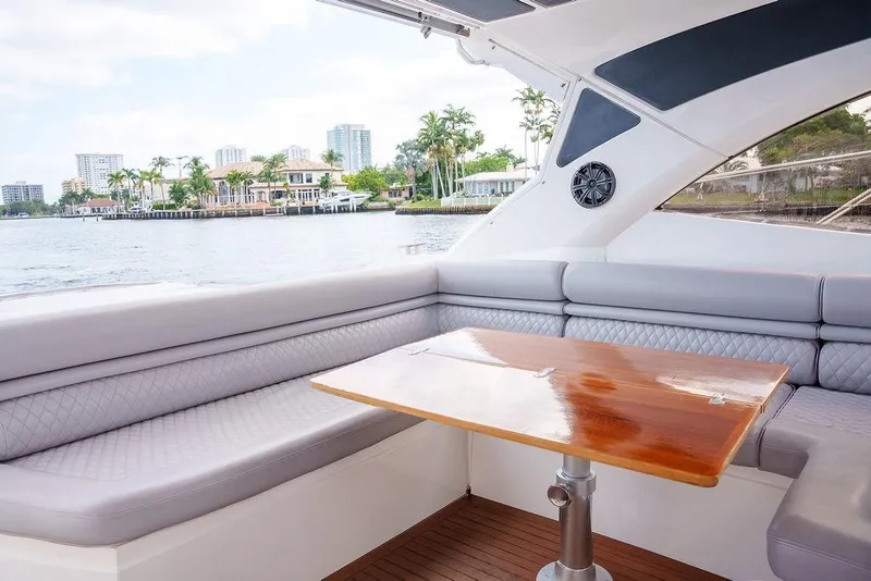 Slide: The Image of Luxurious 2013 Sunseeker Portafino yacht interior with elegant seating and wooden table. - 31
